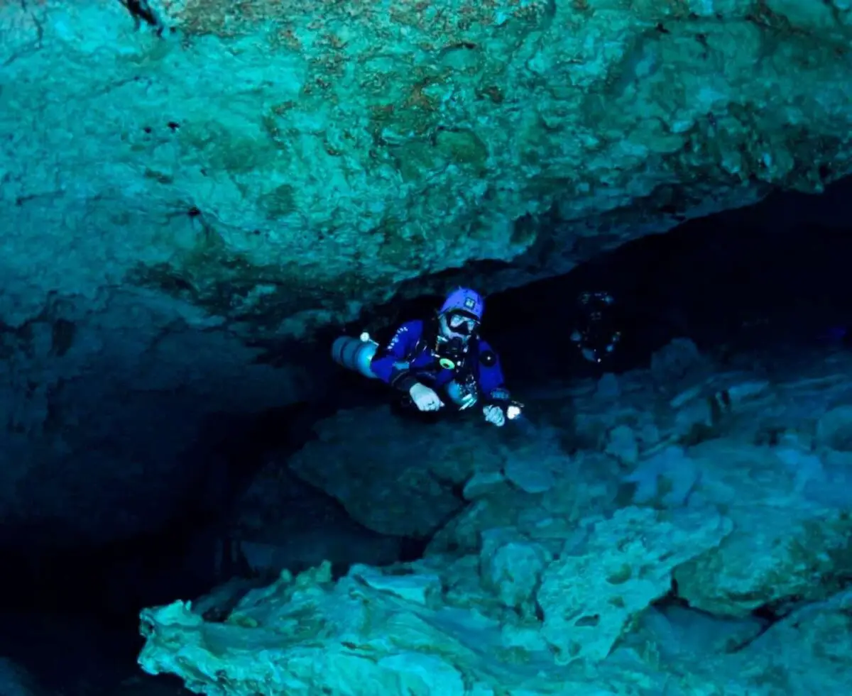 how to start cave diving - a man in a chinese cave diving