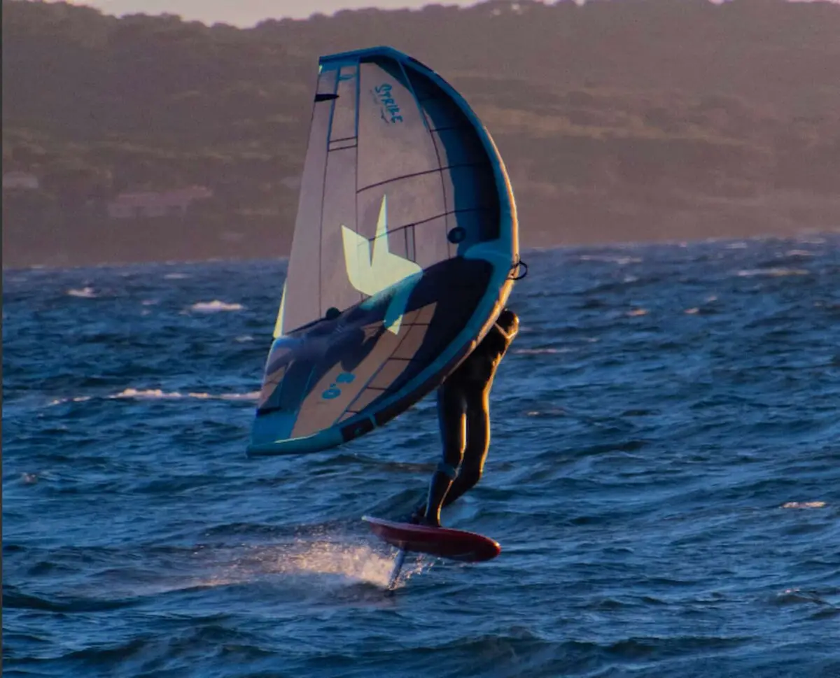 how hard is wing foiling - a guy wing foiling on the ocean