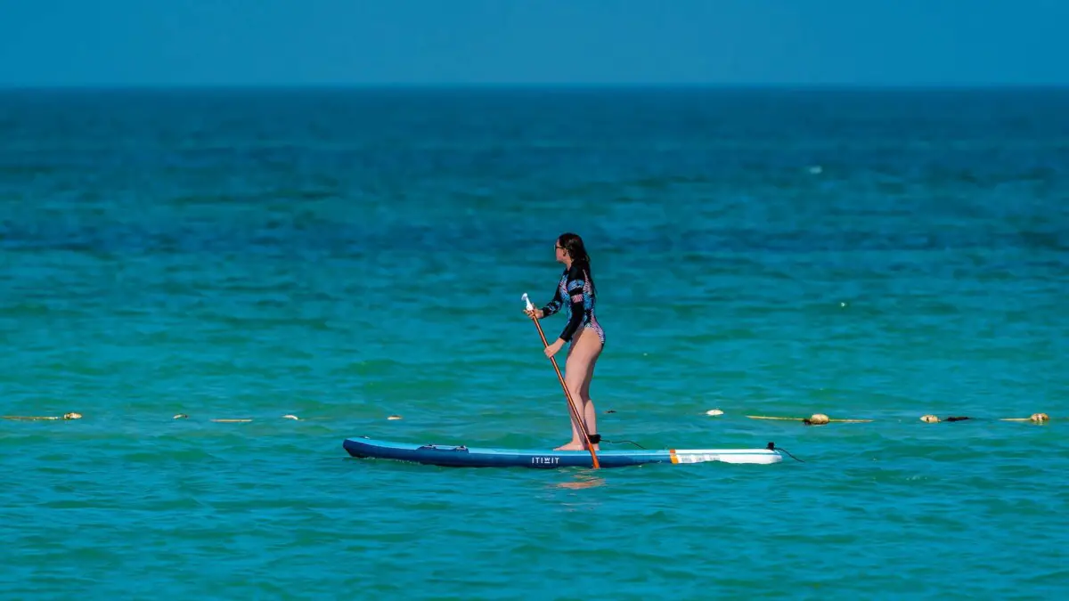 how to start stand up paddleboarding - woman suping on the ocean